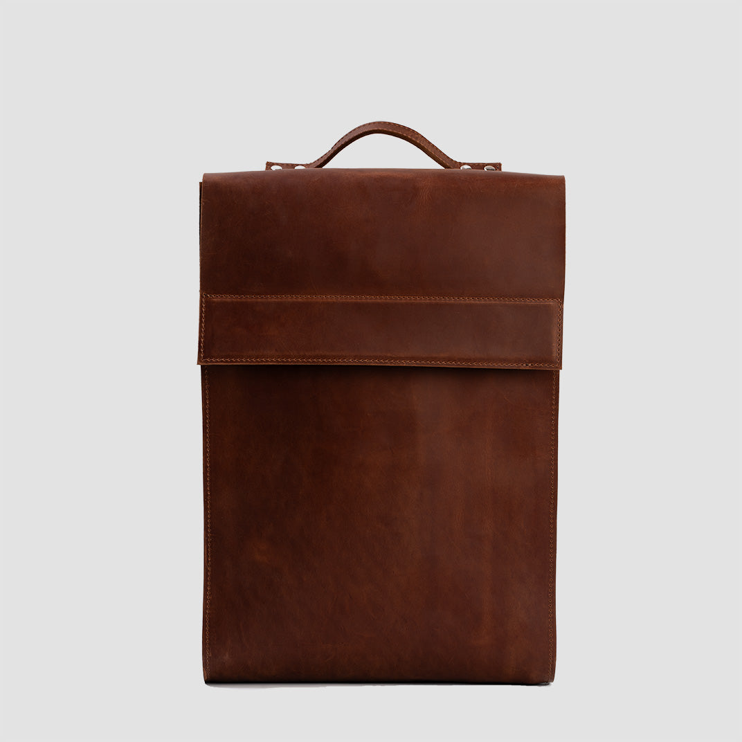 Leather Backpack - Metropolian in Cognac Brown, showcasing its elegant design and functional compartments.