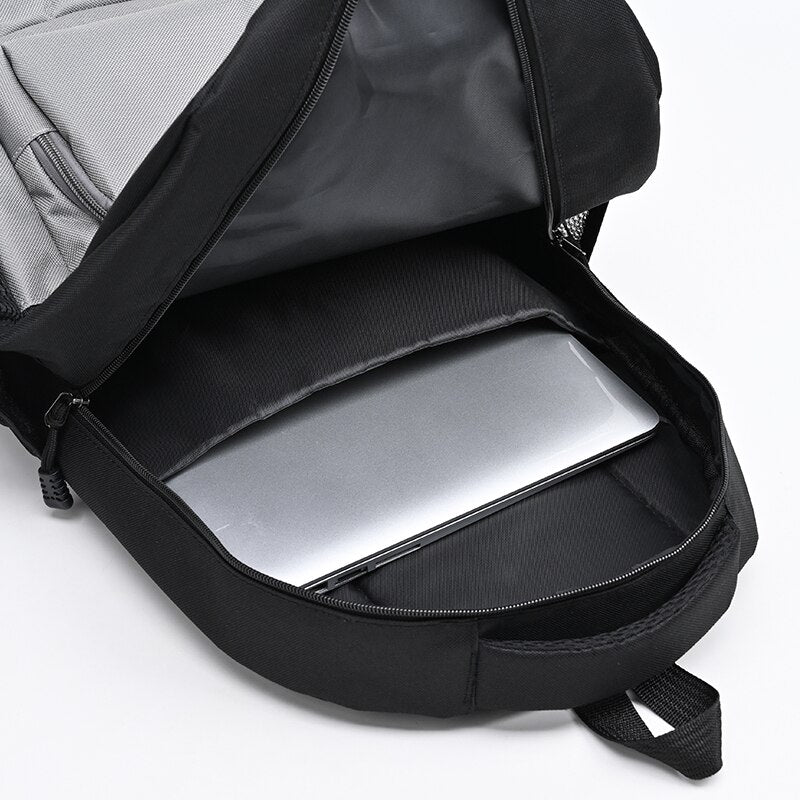 Men's nylon backpack featuring a stylish panelled design, multiple compartments, and a soft handle, ideal for daily use and travel.