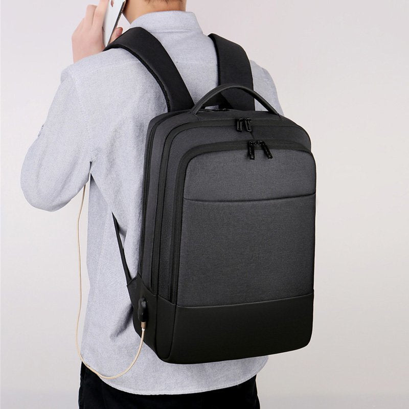 Mens multifunctional waterproof notebook backpack with USB charging port, made from durable Oxford material, featuring multiple pockets and a sleek design.