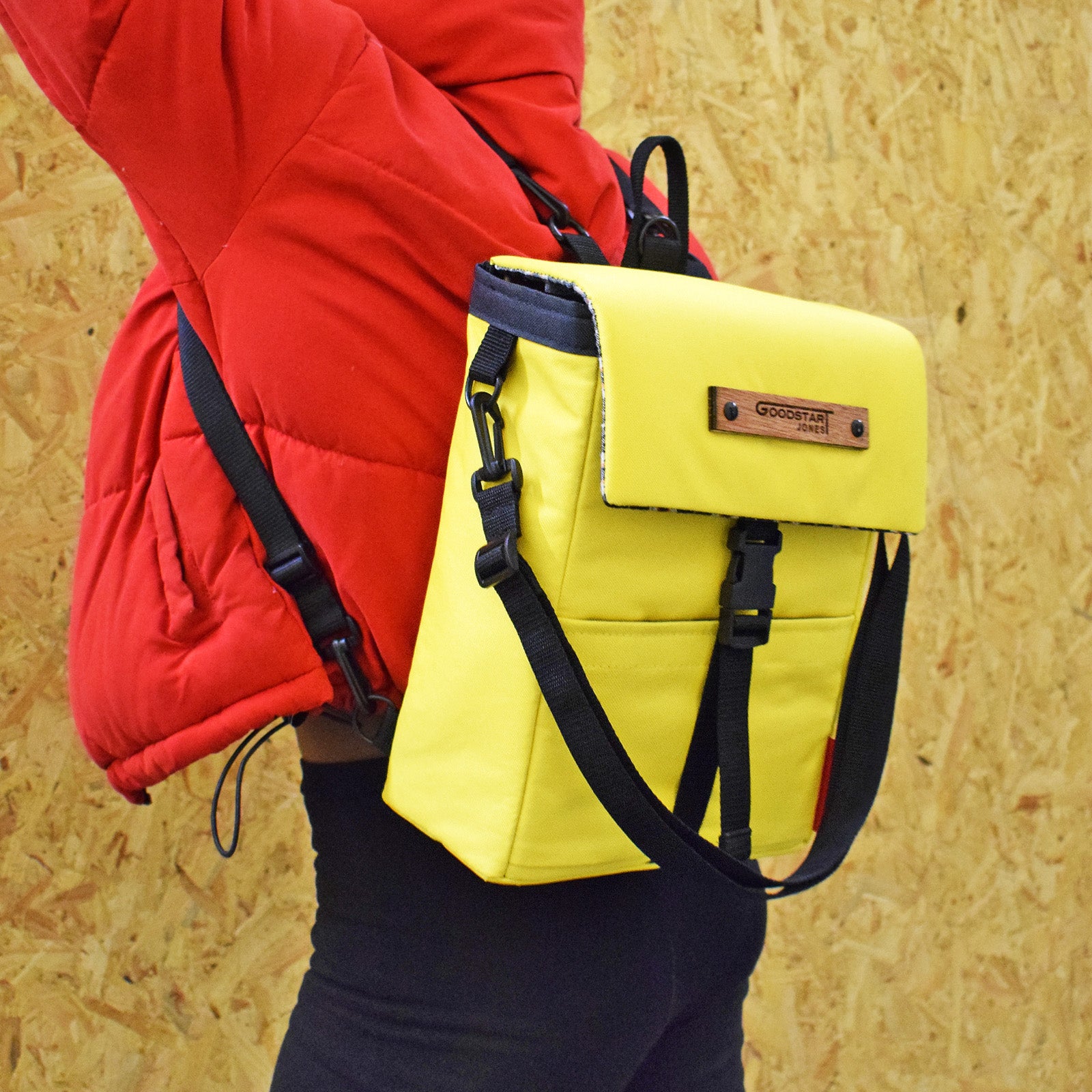 Mini Merchant Backpack in bright yellow, showcasing its multifunctional design as a backpack and crossbody bag.