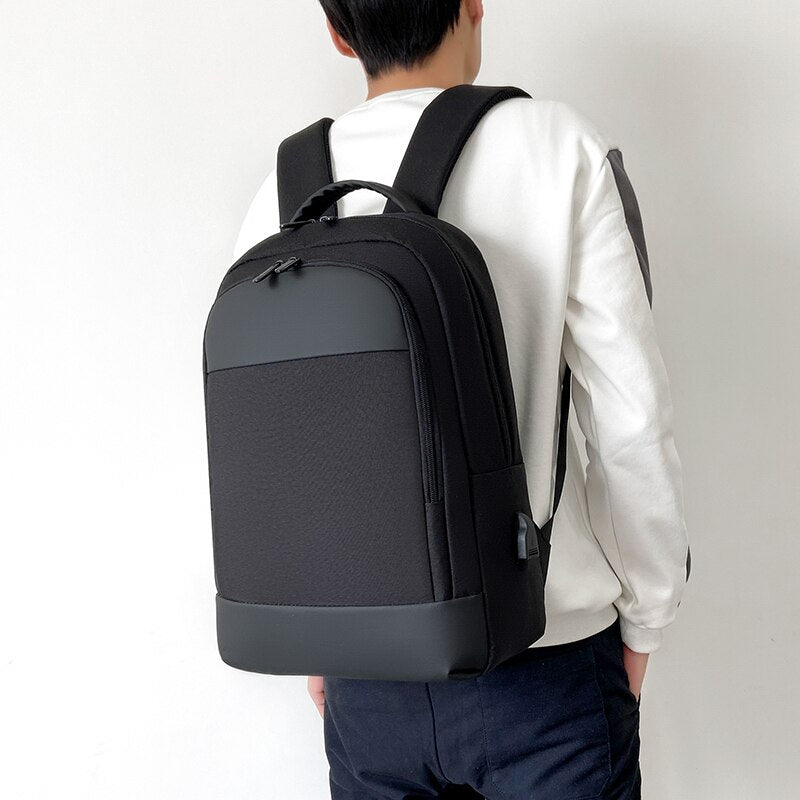 Multifunctional business waterproof Oxford cloth backpack designed for laptops, featuring USB charging port and multiple interior pockets.