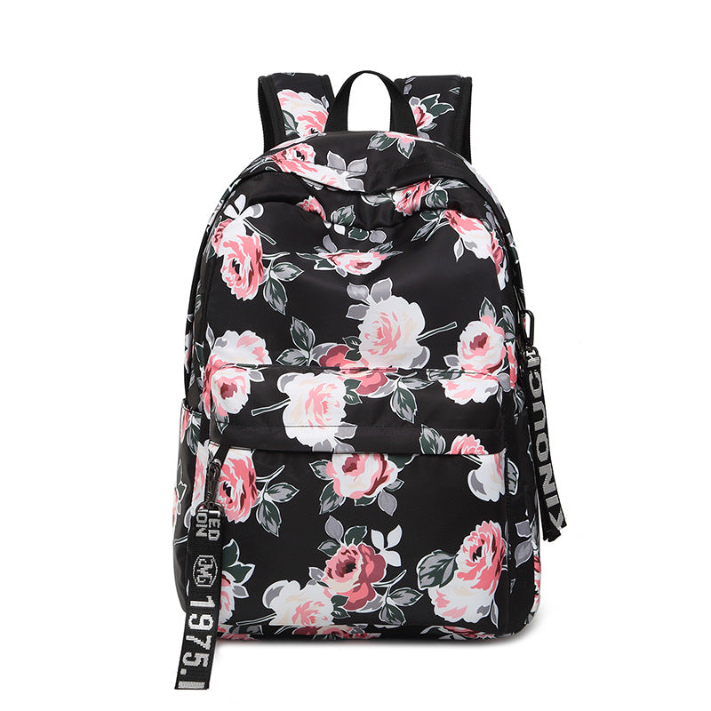 Printed Flowers Nylon Waterproof Ethnic Travel Backpack featuring a vibrant floral design, durable nylon material, and multiple storage compartments.