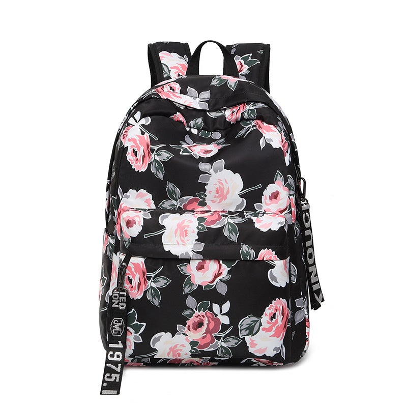 Printed Flowers Nylon Waterproof Ethnic Travel Backpack featuring a vibrant floral design, durable nylon material, and multiple storage compartments.