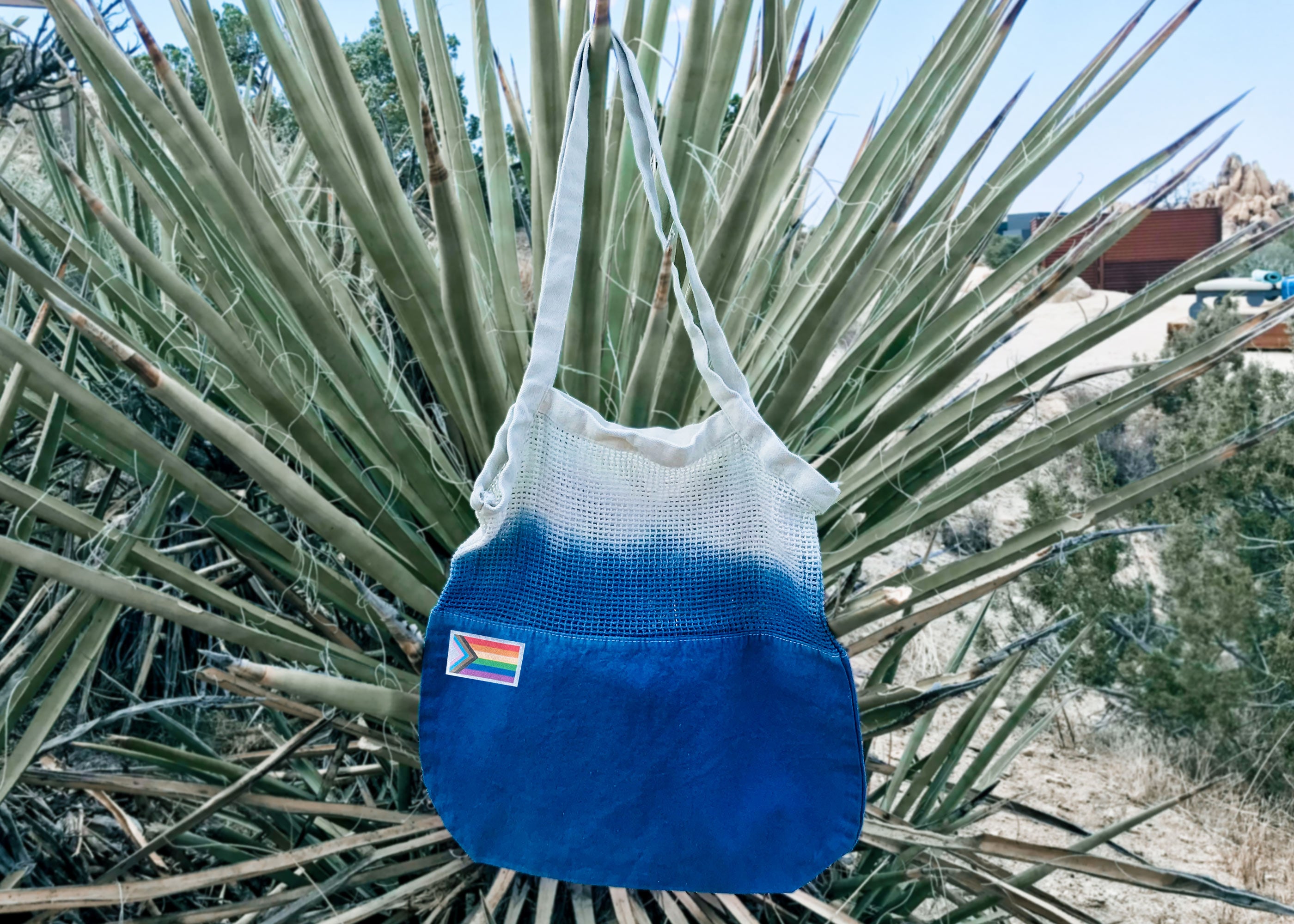 Colorful Tie-Dye Market Tote Bag made of 100% cotton, featuring unique patterns and a Pride Month woven label.