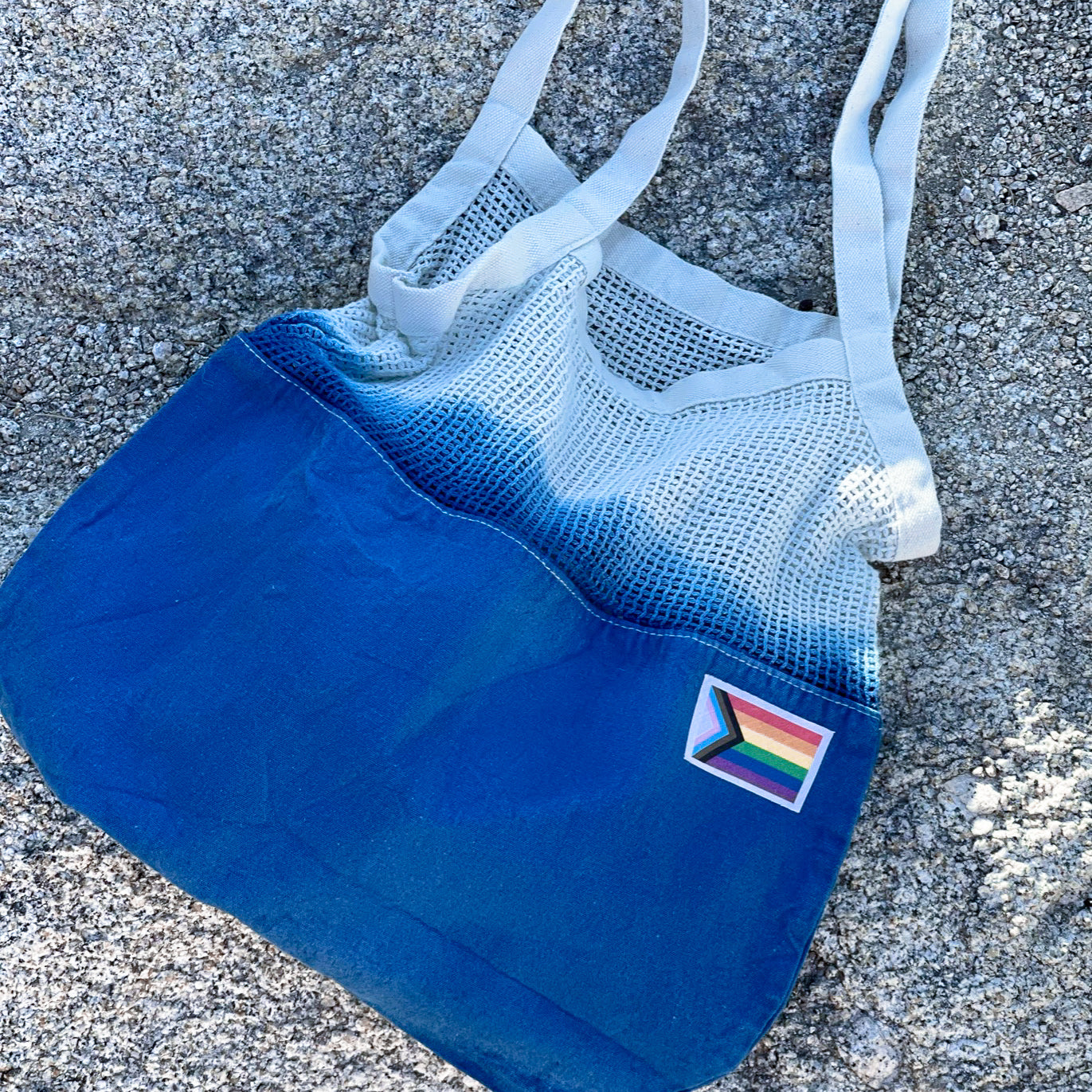 Colorful Tie-Dye Market Tote Bag made of 100% cotton, featuring unique patterns and a Pride Month woven label.