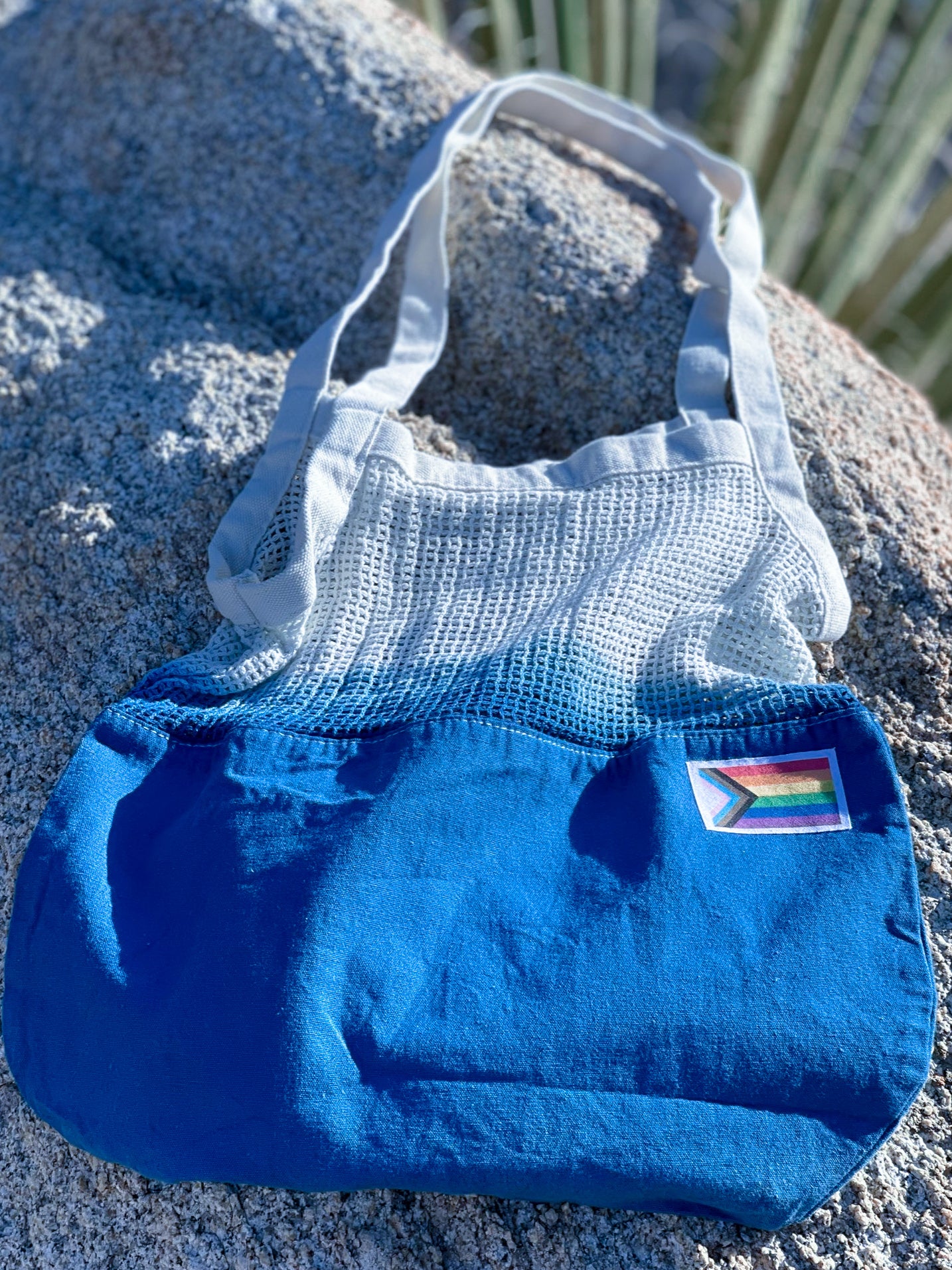 Colorful Tie-Dye Market Tote Bag made of 100% cotton, featuring unique patterns and a Pride Month woven label.