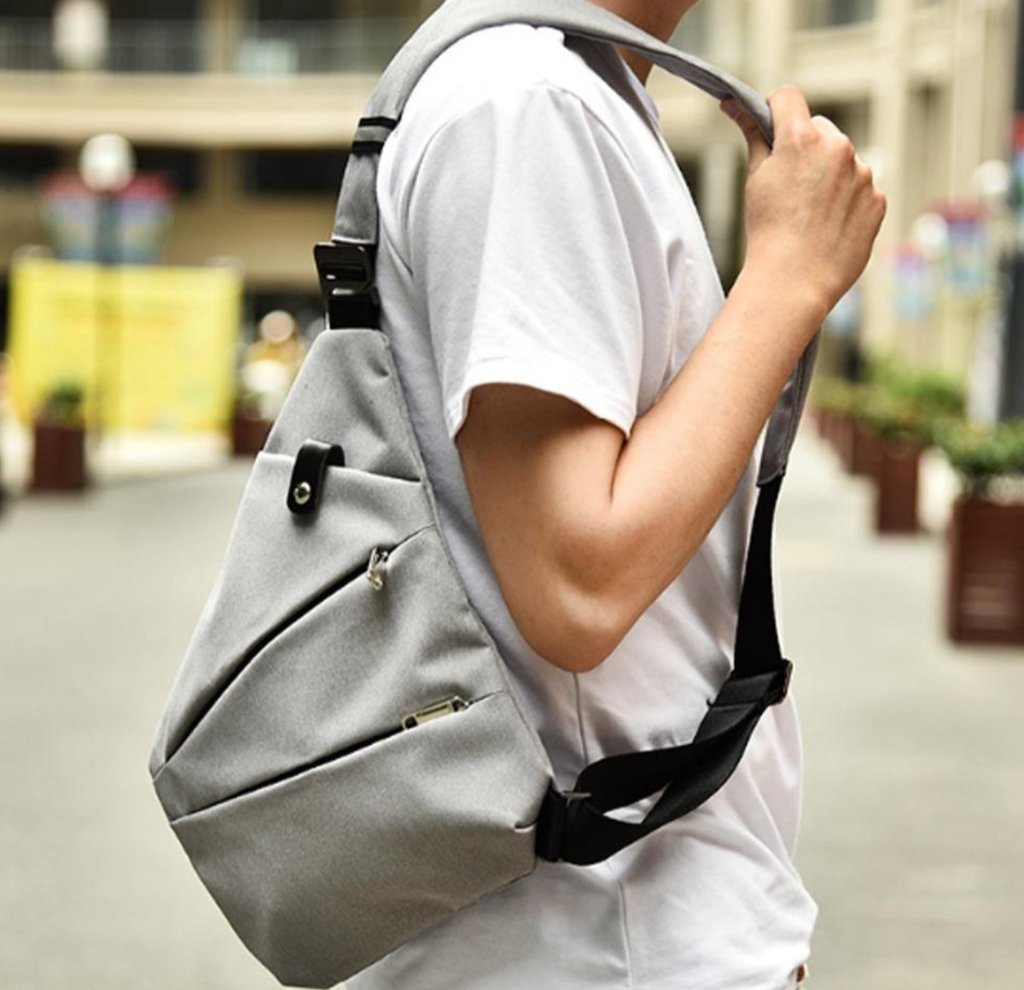 Waterproof Triangle Side Crossbody Bag in gray, showcasing its stylish triangle shape and adjustable strap.