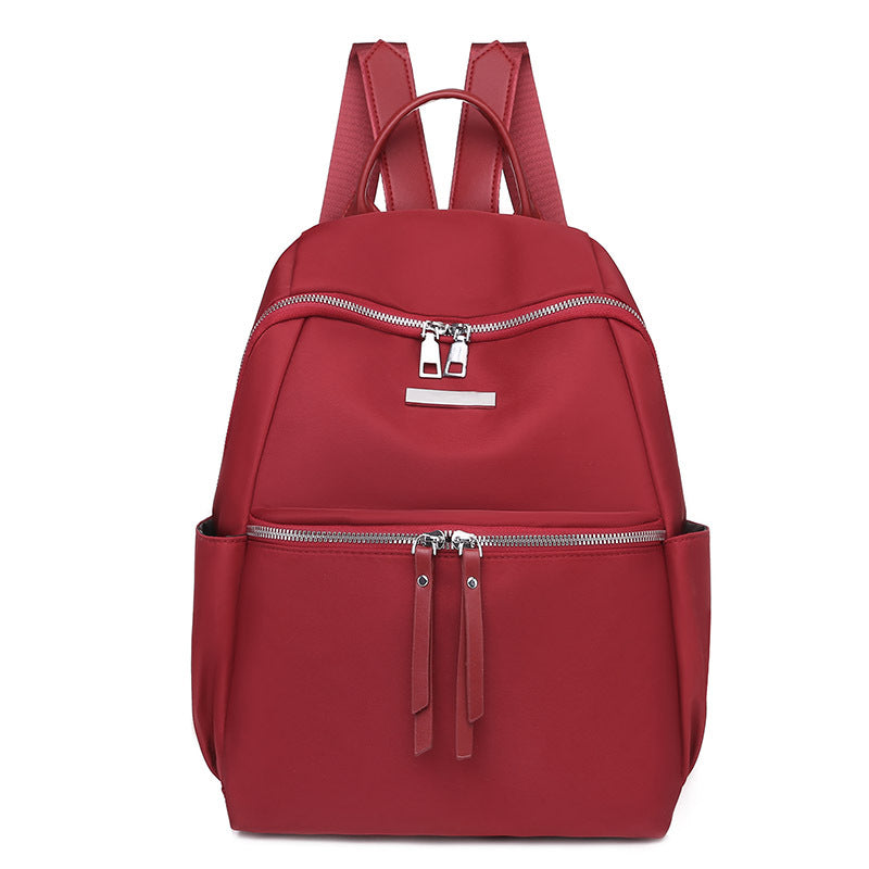 Women's Solid Color Korean Version Oxford Backpack in red, khaki, and black, showcasing its stylish design and durable material.