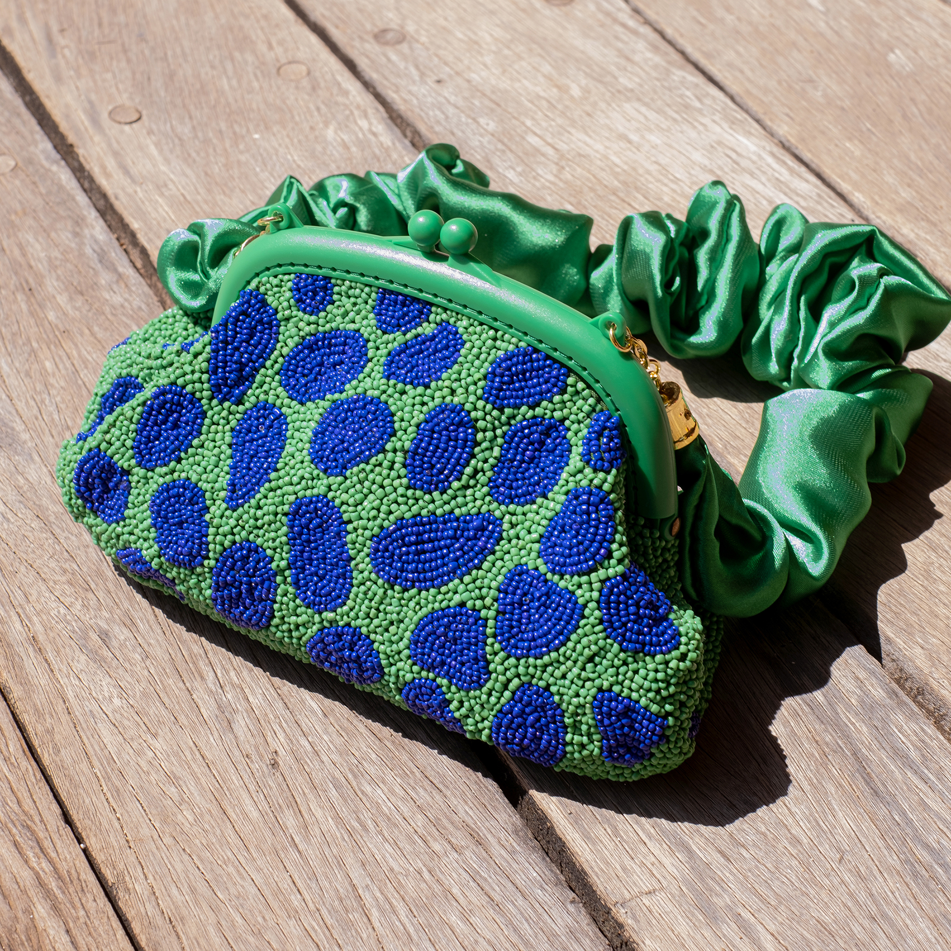 ARNOLDI JADE Hand-beaded Clutch in lush green and blue, featuring intricate glass bead embellishments and a satin scrunch handle.
