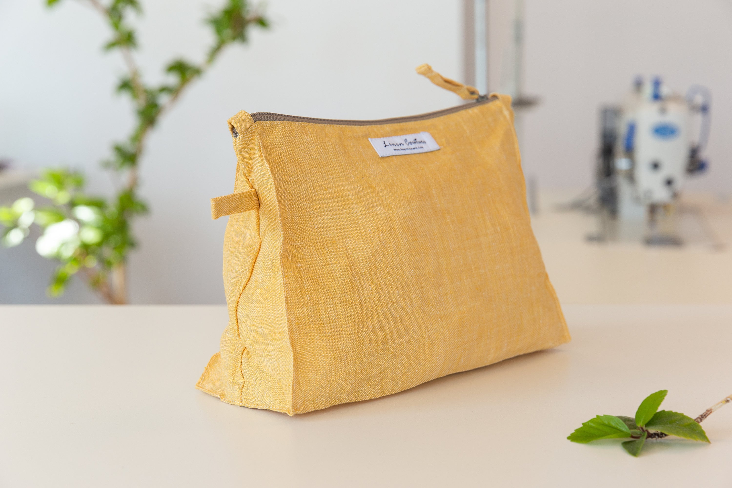 Canary Yellow linen large cosmetic bag with zipper closure, showcasing its soft texture and spacious interior, perfect for organizing cosmetics and toiletries.