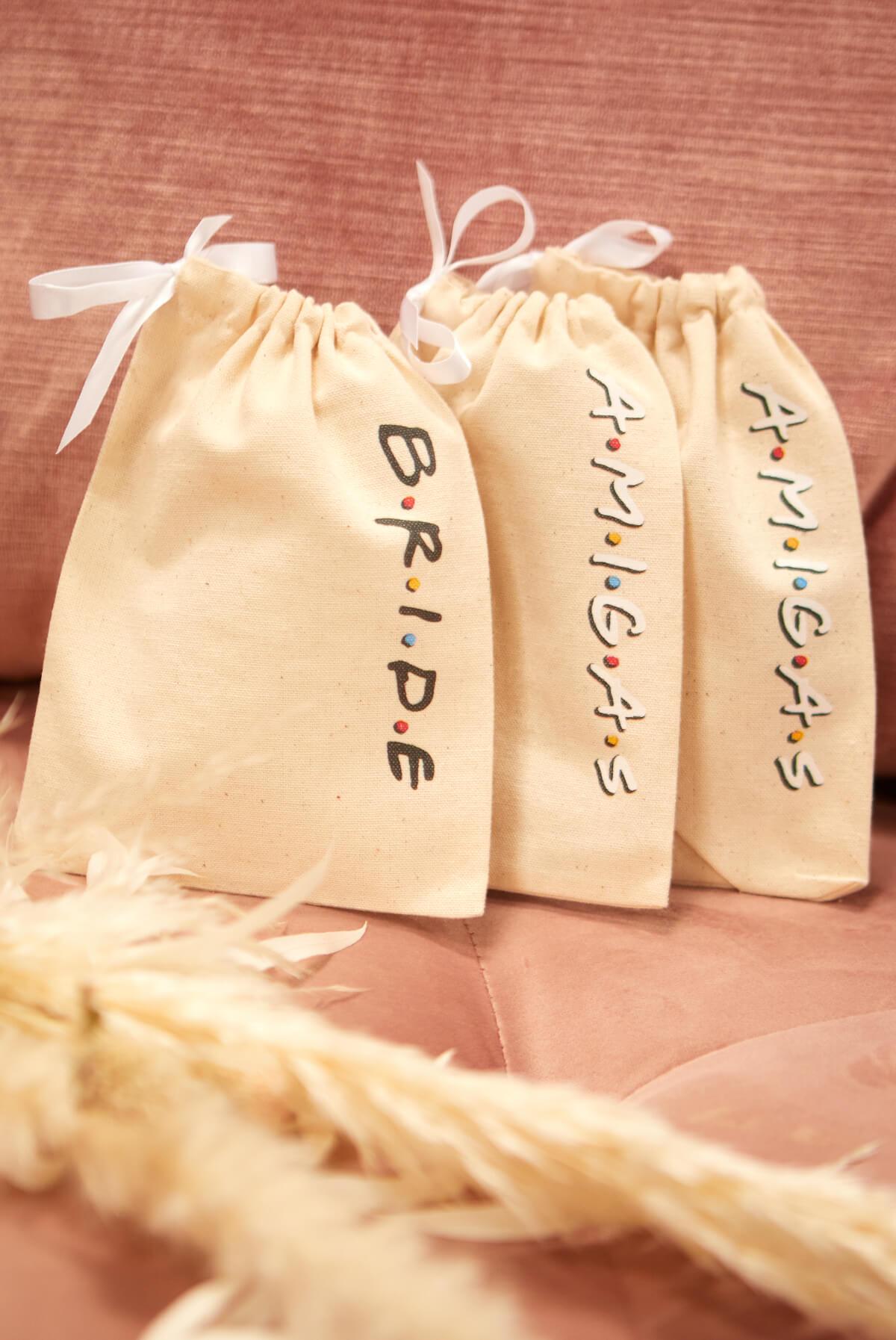FRIENDS Bride Amigas Hangover Kit Bags in canvas, featuring B.R.I.D.E and A.M.I.G.A.S embellishments, perfect for party favors.