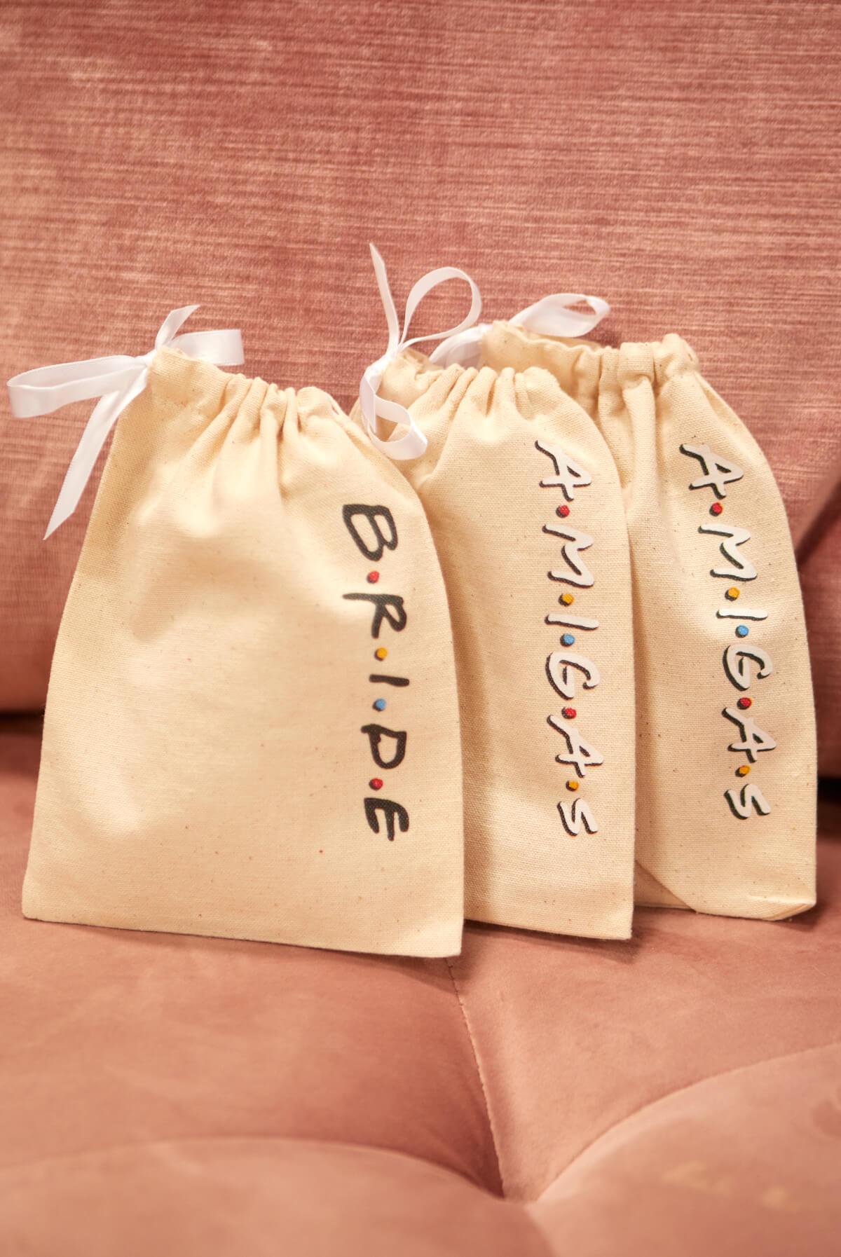 FRIENDS Bride Amigas Hangover Kit Bags in canvas, featuring B.R.I.D.E and A.M.I.G.A.S embellishments, perfect for party favors.
