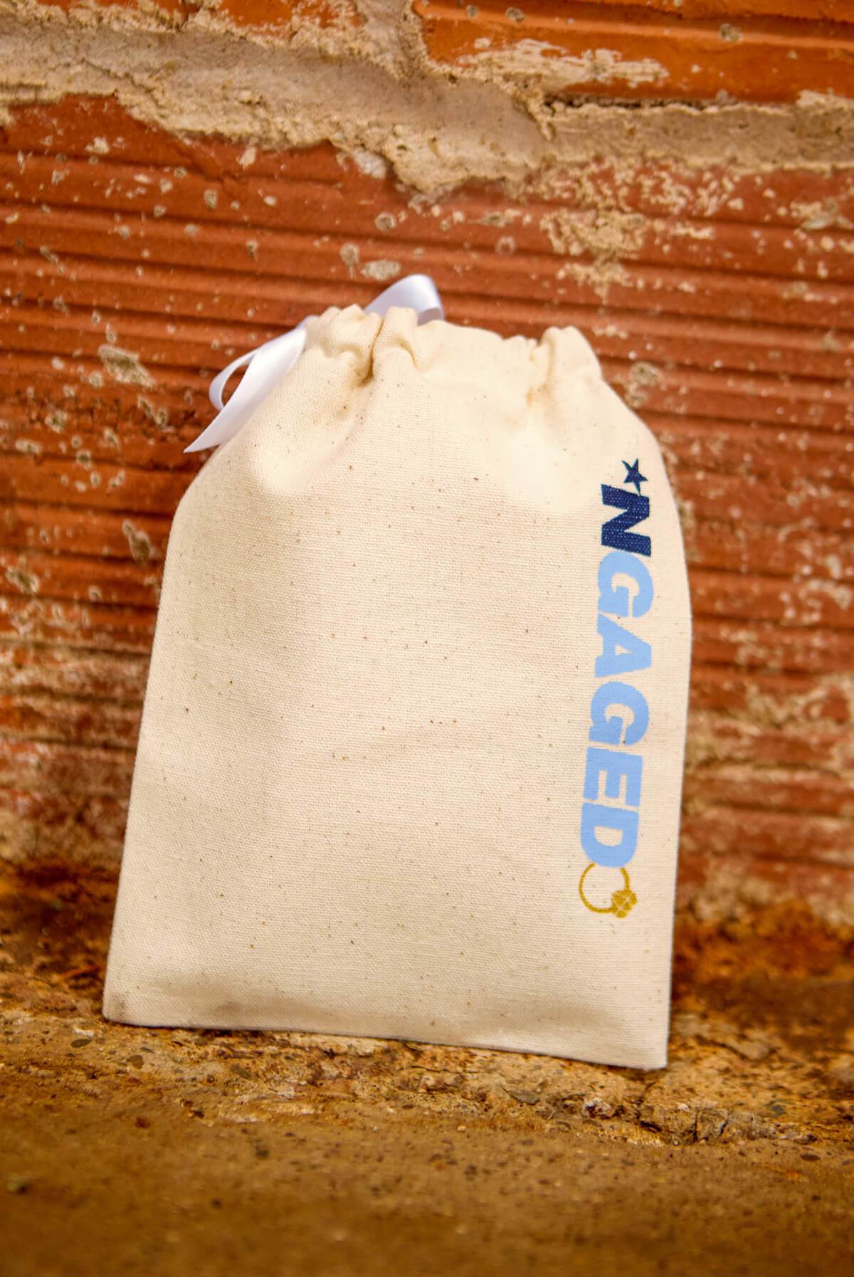 A collection of *NGAGED | ByeByeBye Boy Band Hangover Kit Bags, featuring fun phrases on stylish canvas pouches, perfect for celebrations.