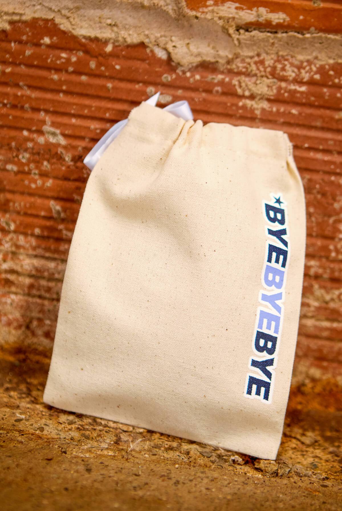 A collection of *NGAGED | ByeByeBye Boy Band Hangover Kit Bags, featuring fun phrases on stylish canvas pouches, perfect for celebrations.