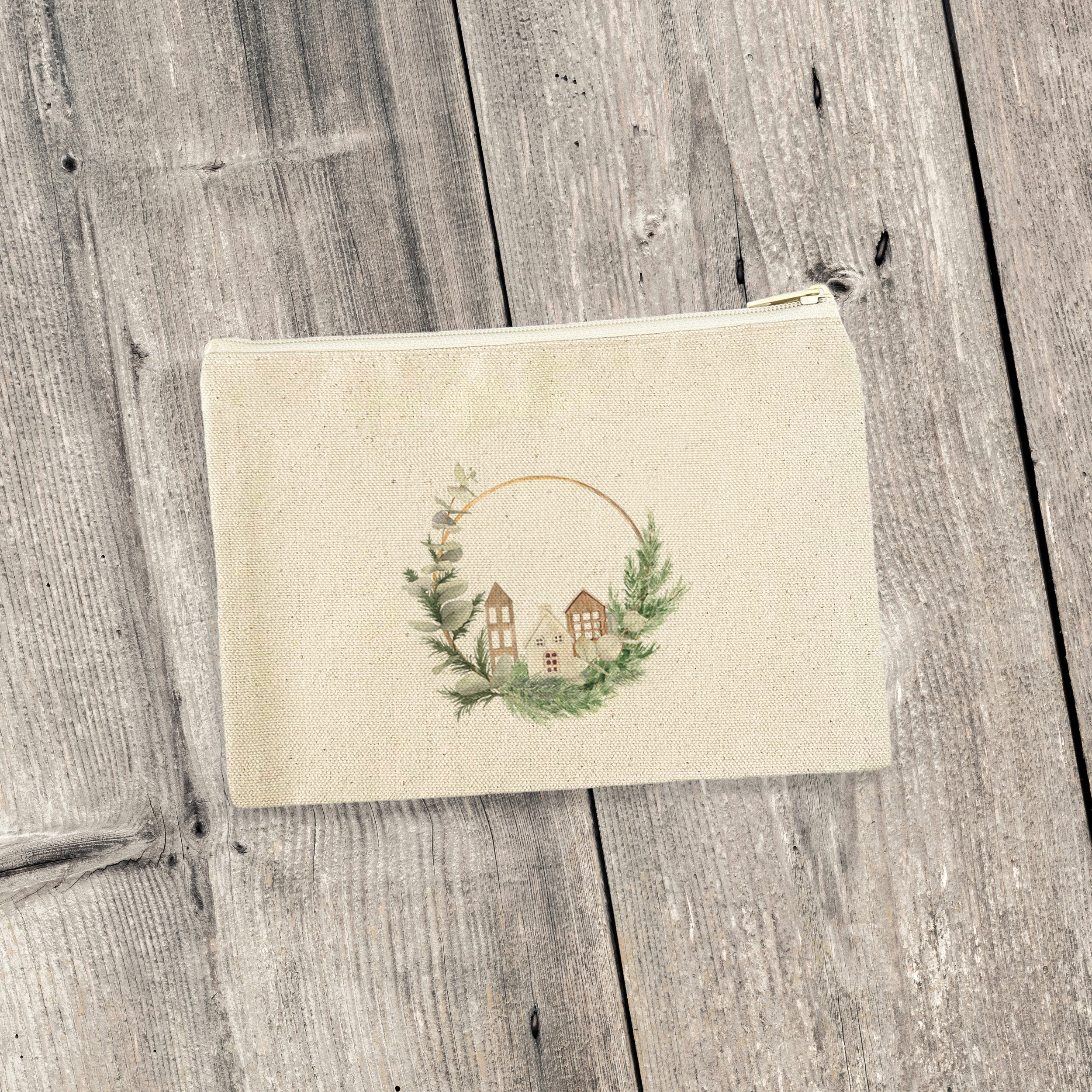 Wood Village Wreath canvas zipper pouch featuring a natural color zipper and vibrant printed design, perfect for organization.