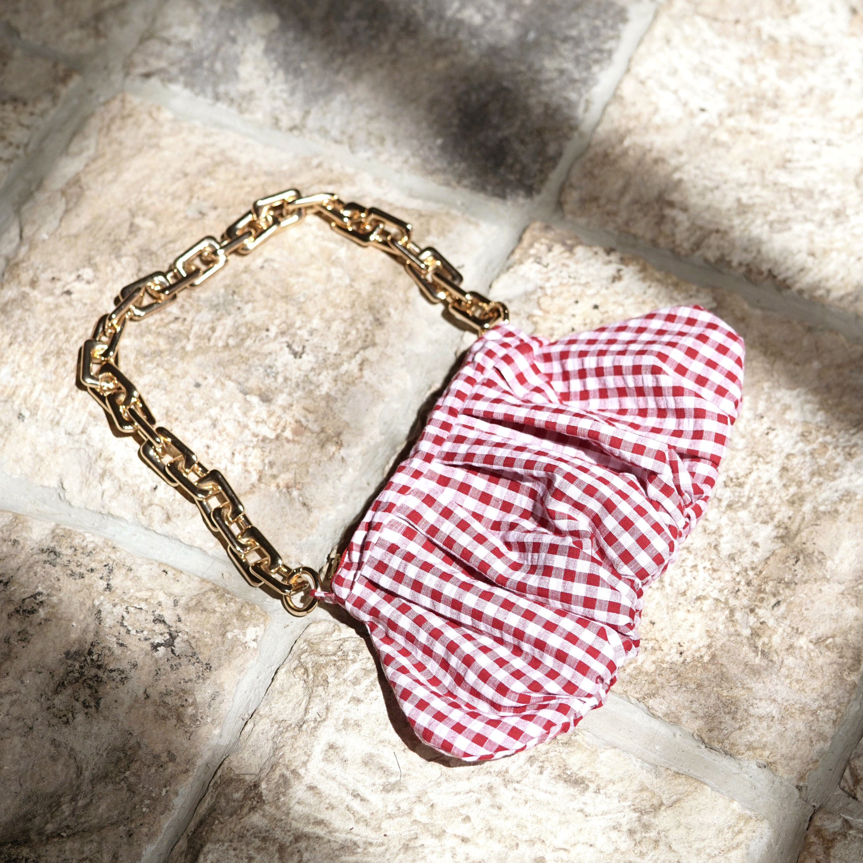 AWAN Ruffle Bag in Red Gingham, featuring a slouchy design, gold-tone chain, and crafted from 100% linen, perfect for day-to-night use.
