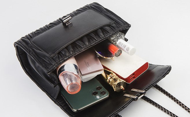 Embroidery Camellia Chain bag in vegan leather with pewter fittings and lock closure, showcasing intricate floral embroidery.