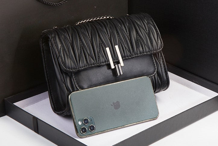 Embroidery Camellia Chain bag in vegan leather with pewter fittings and lock closure, showcasing intricate floral embroidery.