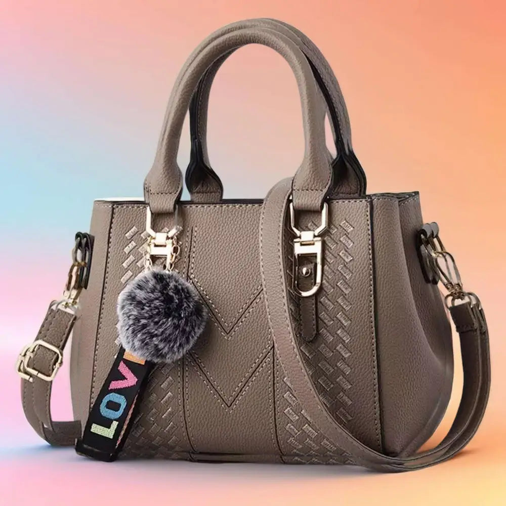 A stylish embroidered leather handbag with a unique design, featuring an adjustable strap and spacious interior, perfect for women on the go.