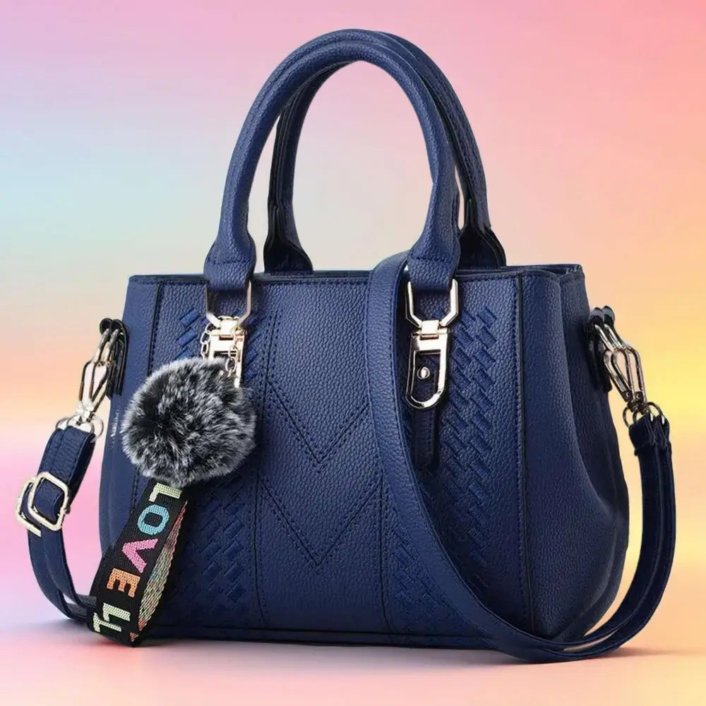 A stylish embroidered leather handbag with a unique design, featuring an adjustable strap and spacious interior, perfect for women on the go.