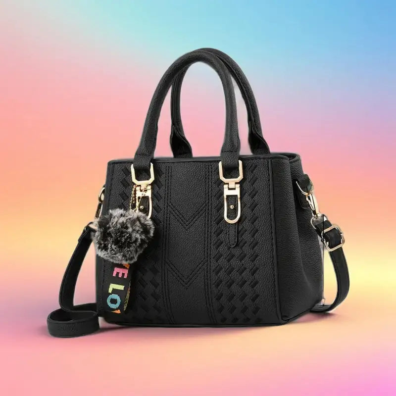 A stylish embroidered leather handbag with a unique design, featuring an adjustable strap and spacious interior, perfect for women on the go.