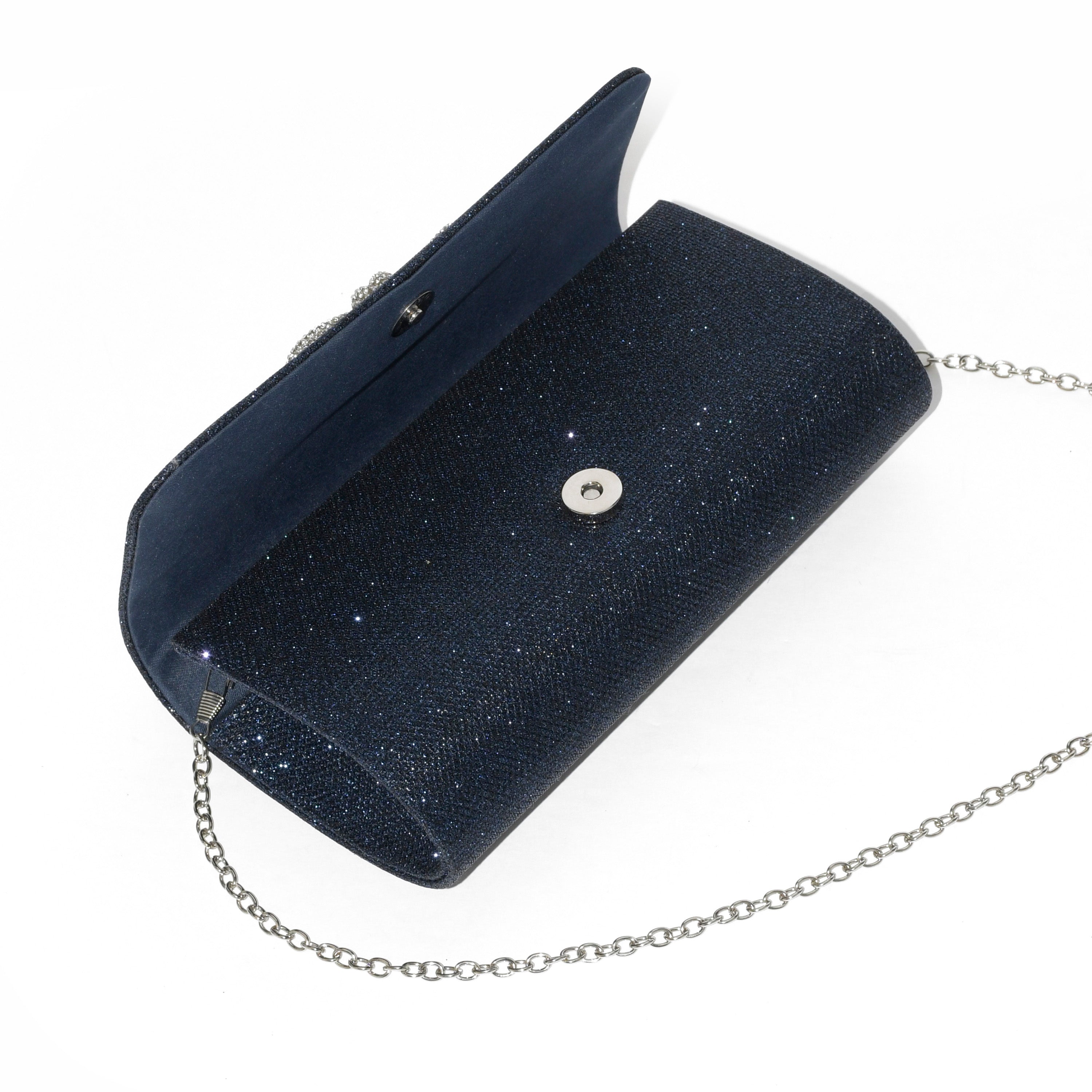 Elegant evening bag with a sparkling glitter bow, featuring a detachable chain strap and magnetic snap closure.