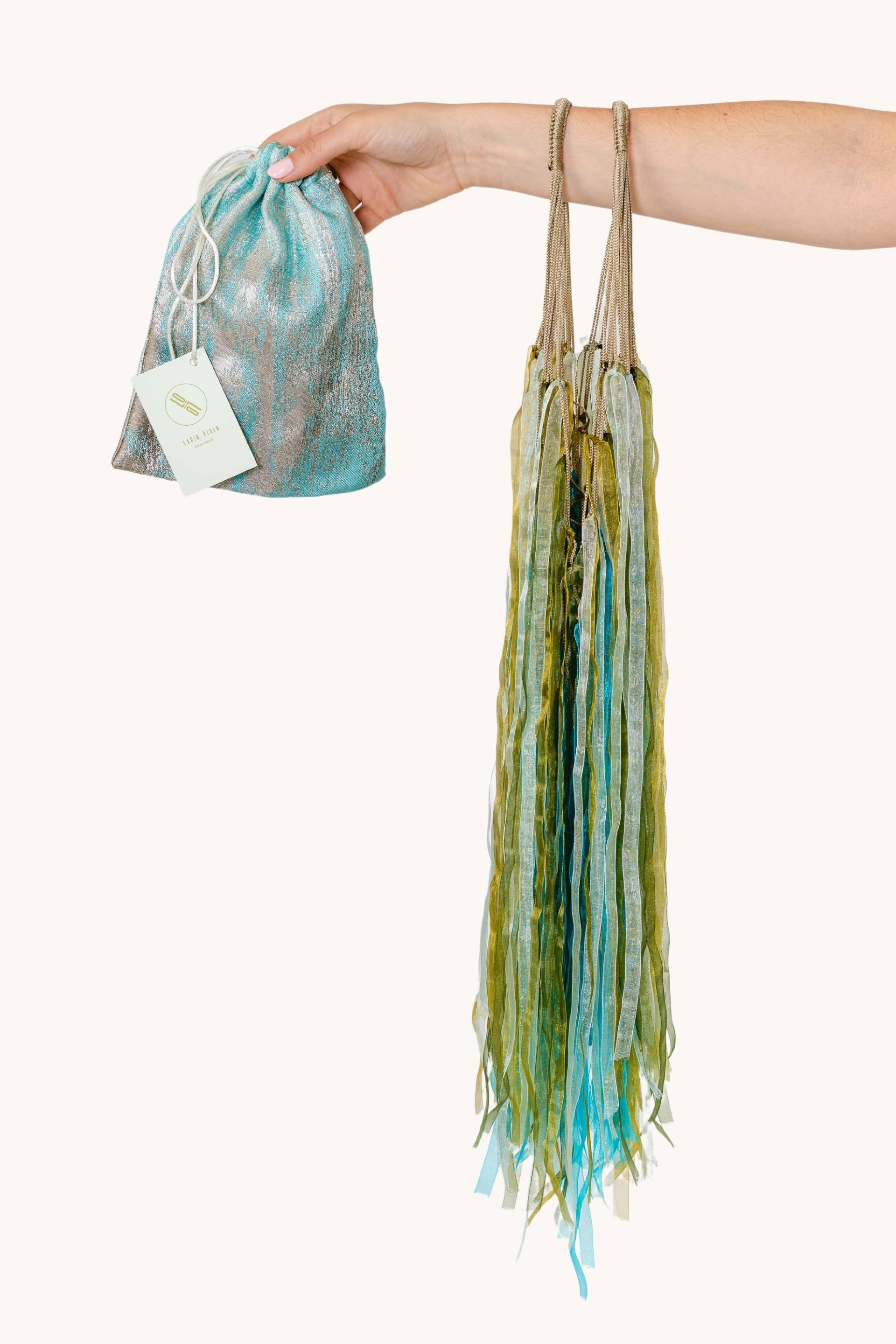 A beautiful Flower Hat Jellyfish showcasing its translucent bell and dark pinstripes, surrounded by shades of green and blue.