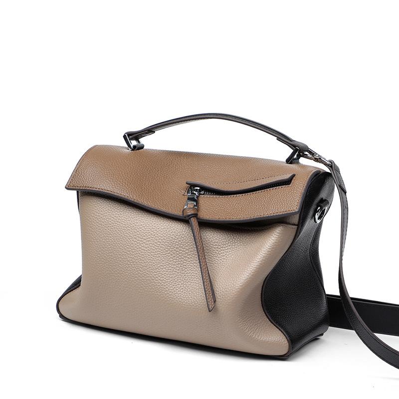 A stylish genuine leather shoulder bag for women, featuring a color contrast design and soft handle, perfect for everyday use.