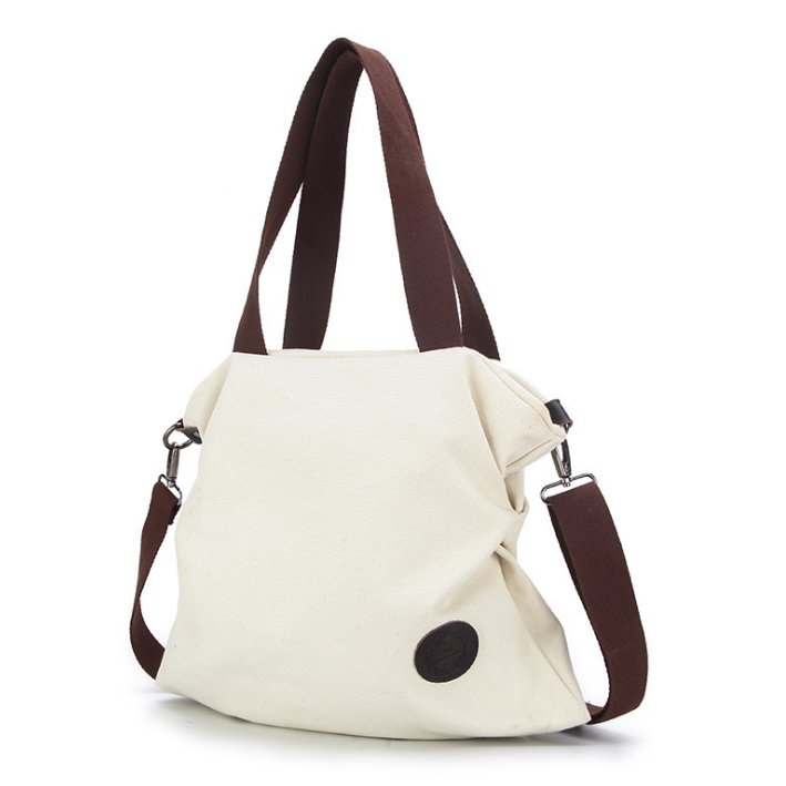 High Quality Fashion Canvas Shoulder Bag with rivet decoration and cotton lining, measuring 38*10*41cm, ideal for stylish everyday use.