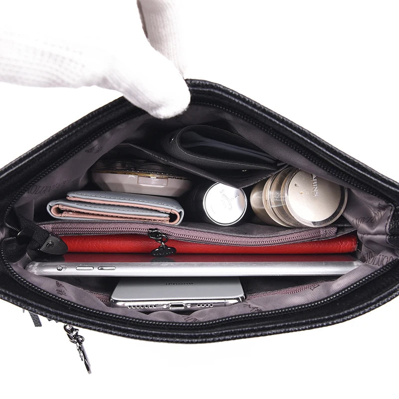 Lightweight shoulder bag made of high-quality leather with glossy finish and detachable hardware buckle.