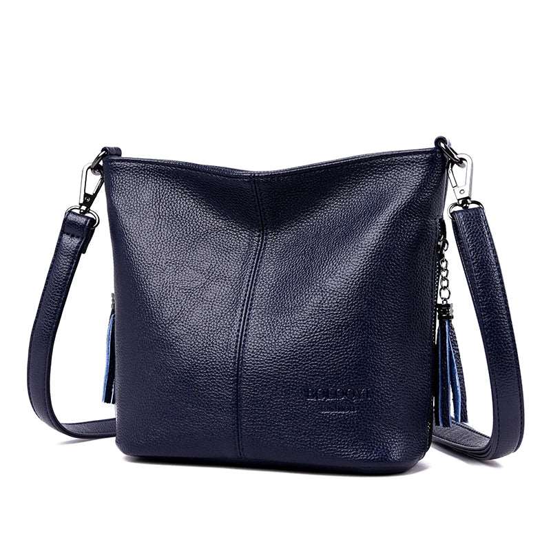 Lightweight shoulder bag made of high-quality leather with glossy finish and detachable hardware buckle.