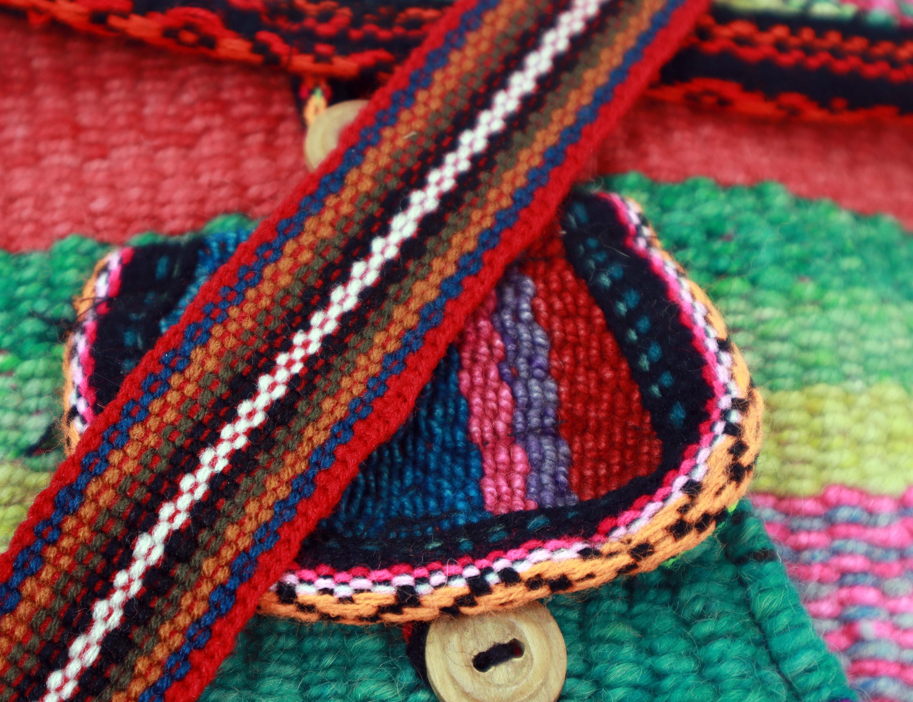 Mint and Fuchsia Artisan Woven Button Crossbody Bag showcasing vibrant colors and intricate designs.