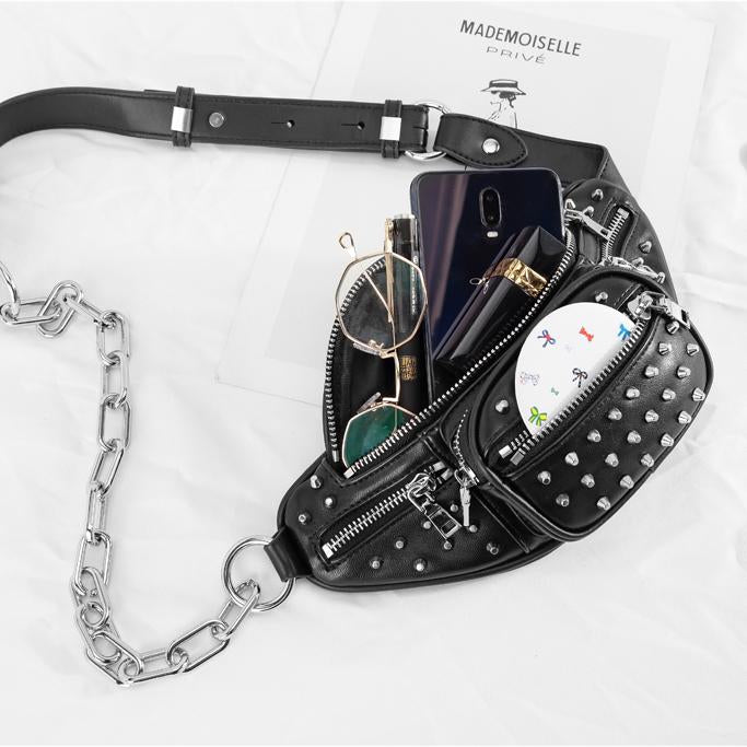Moto Rivets Fanny Crossbody Bag in black studded vegan leather with adjustable chain strap and multiple zipper pockets.
