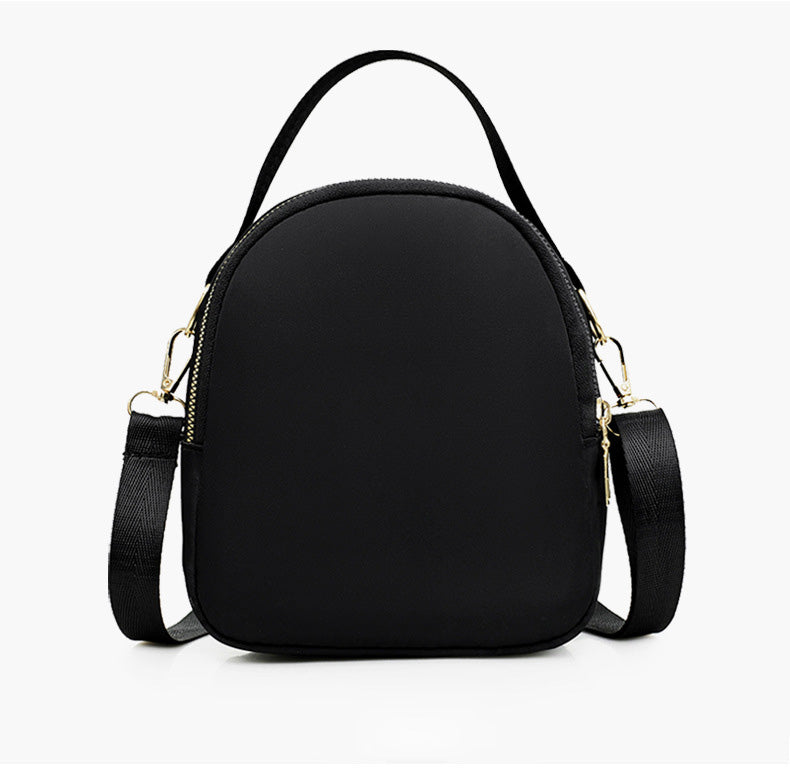 A stylish nylon quilted bag featuring multiple zipper pockets, adjustable strap, and gold-tone hardware.