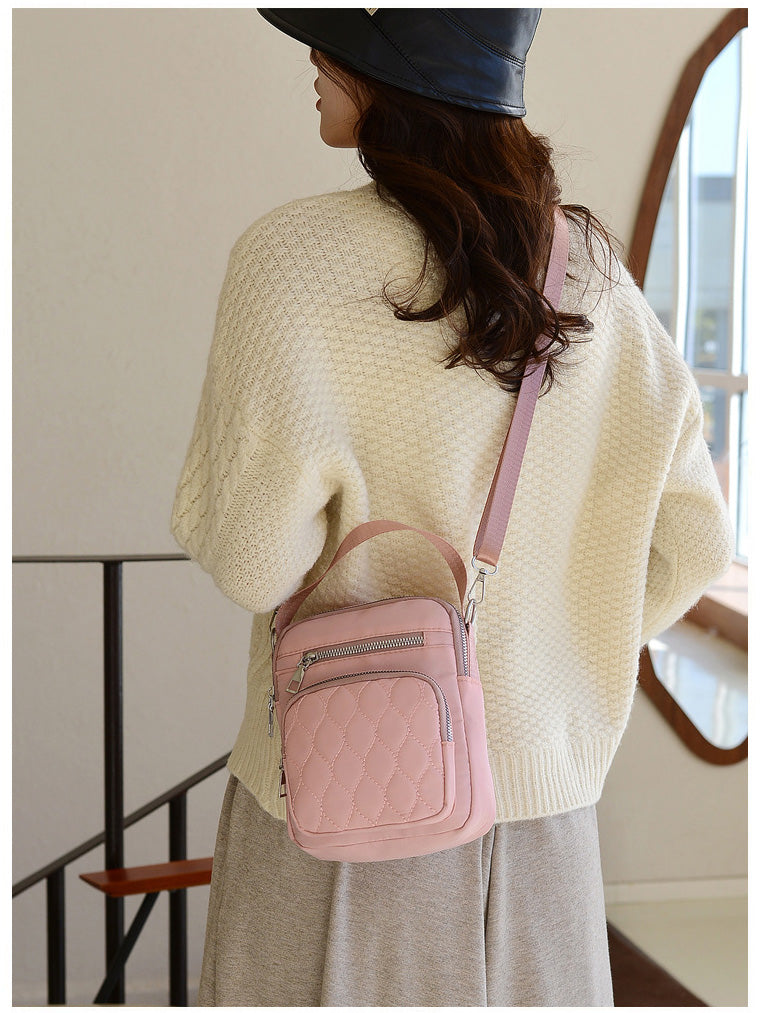 A stylish NYLON QUILTED BAG in black, featuring multiple zipper pockets and an adjustable strap, perfect for daily use.