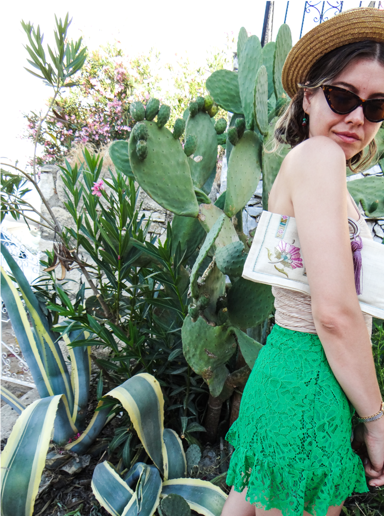 PRUAANA bag featuring traditional Turkish embroidery, antique metal handle, and a decorative tassel.