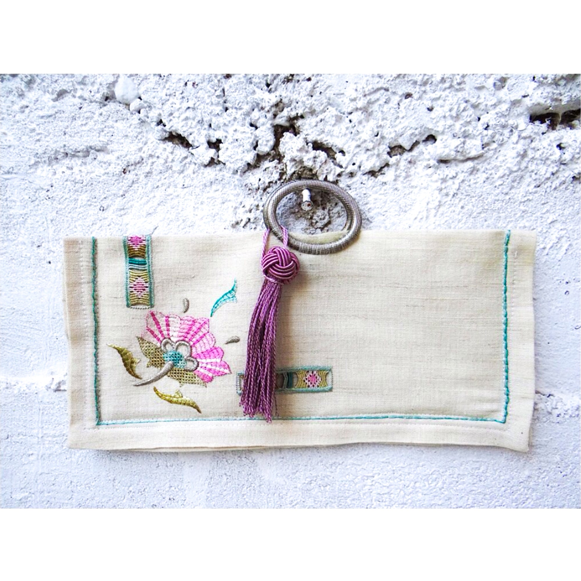 PRUAANA bag featuring traditional Turkish embroidery, antique metal handle, and a decorative tassel.