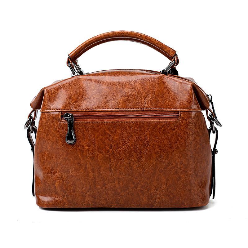 A stylish Retro High Quality Oil-wax Leather Lady's Messenger Bag showcasing its elegant design and compartments.