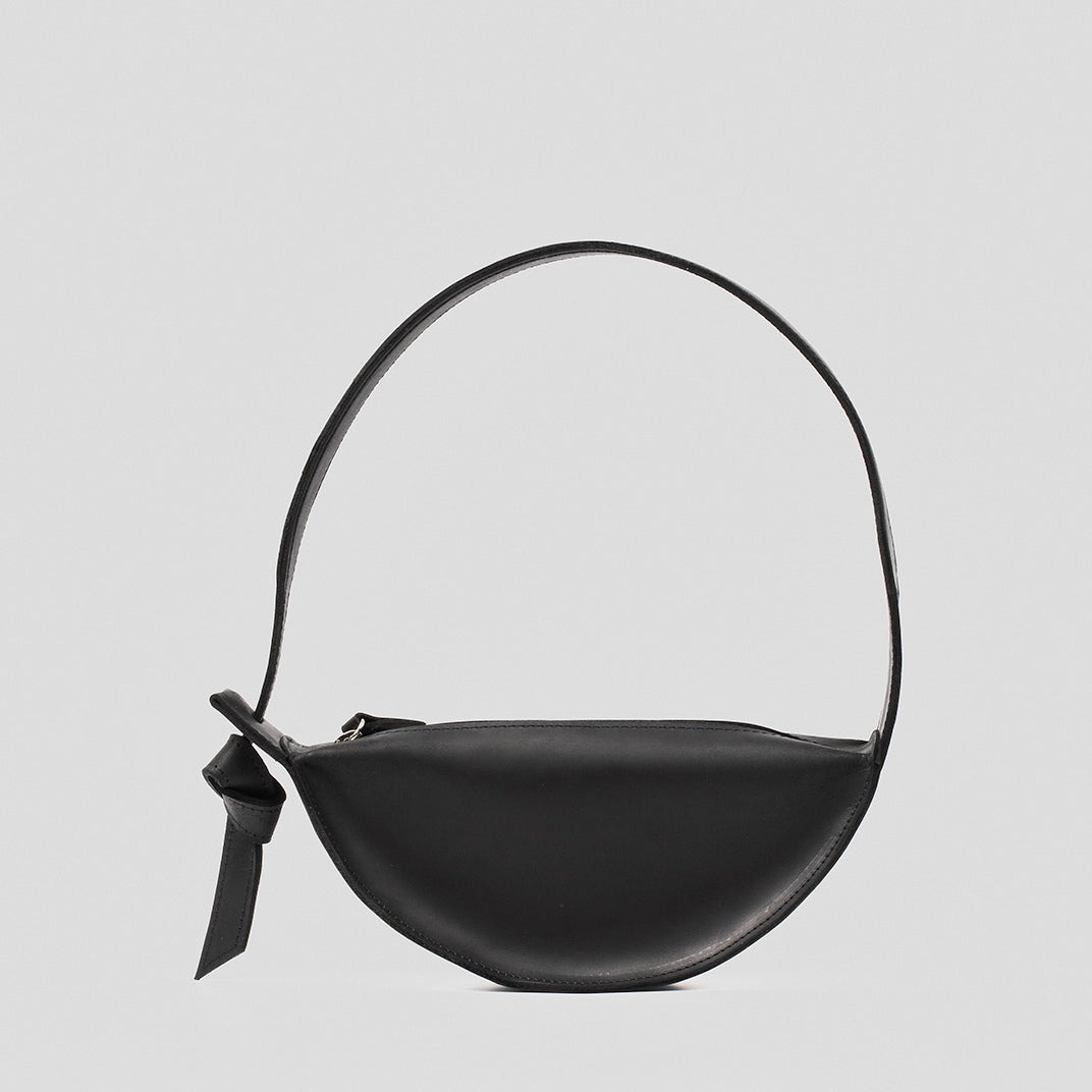 Crescent Black Shoulder Bag made of durable leather with an elegant half-moon shape and adjustable strap.