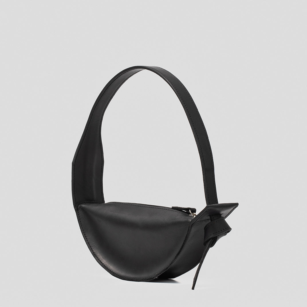 Crescent Black Shoulder Bag made of durable leather with an elegant half-moon shape and adjustable strap.