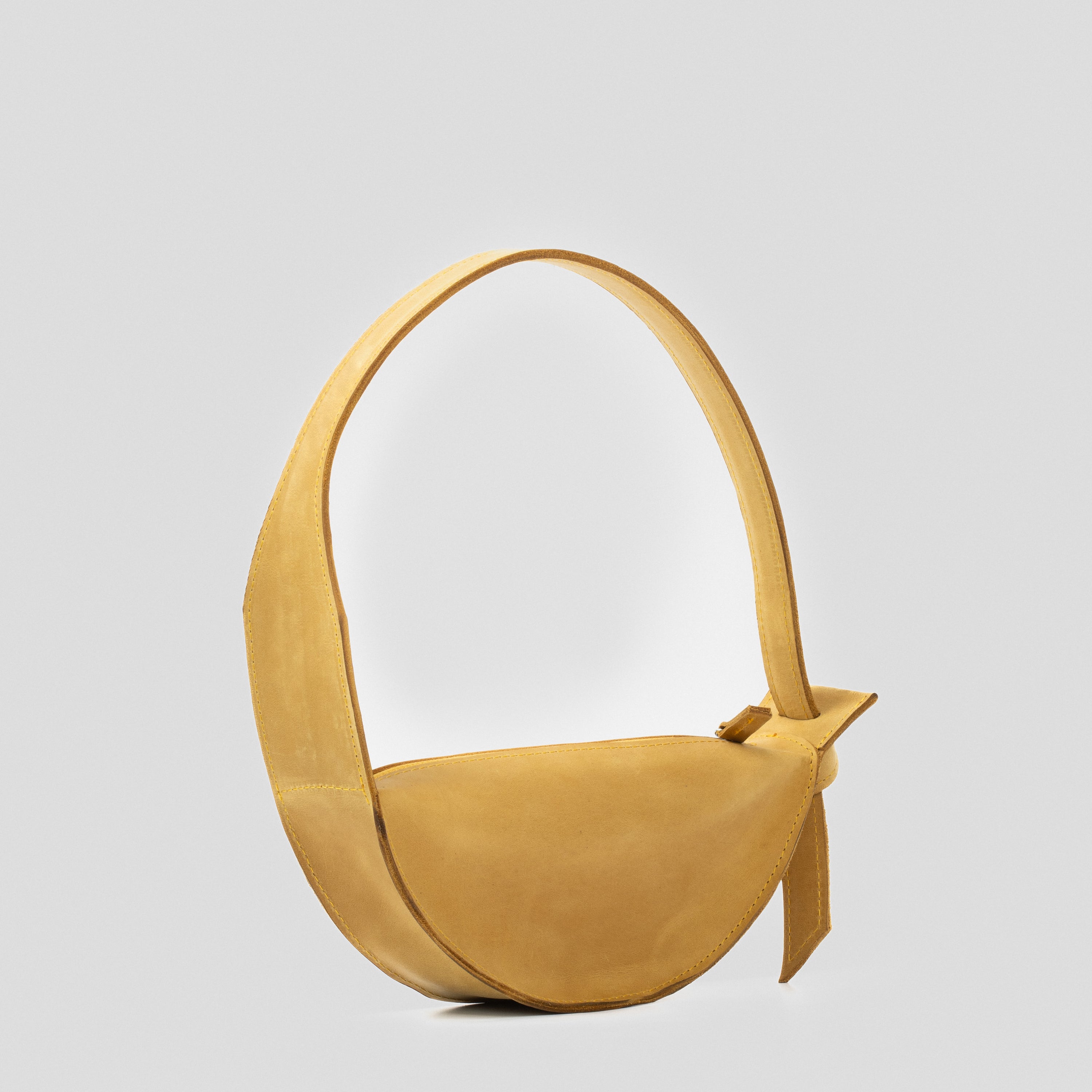 Crescent Yellow Shoulder Bag featuring a half-moon design, adjustable strap, and durable leather construction.
