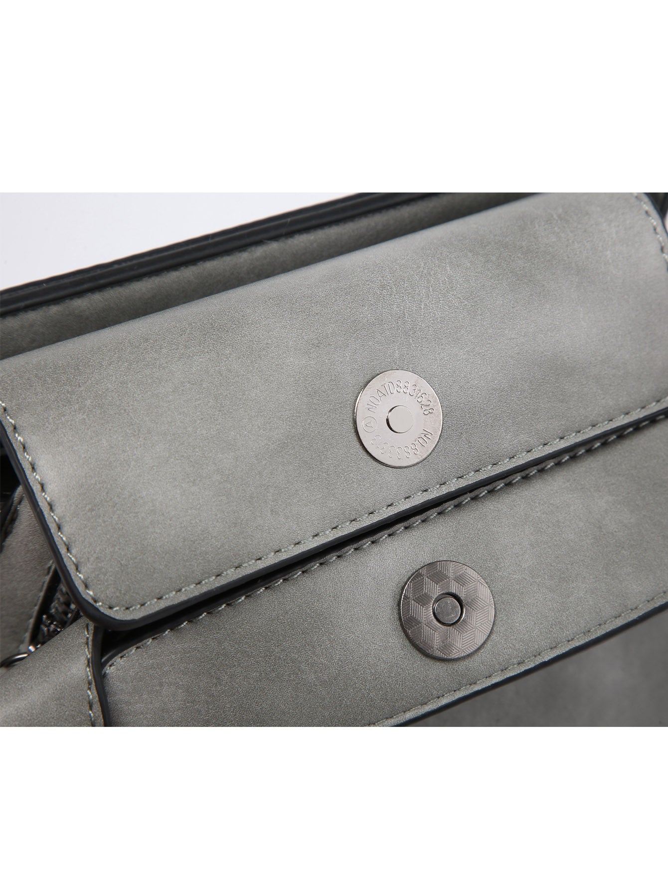 Small crossbody bag in vegan leather with triple compartments and pewter fitting, showcasing its stylish design and practicality.