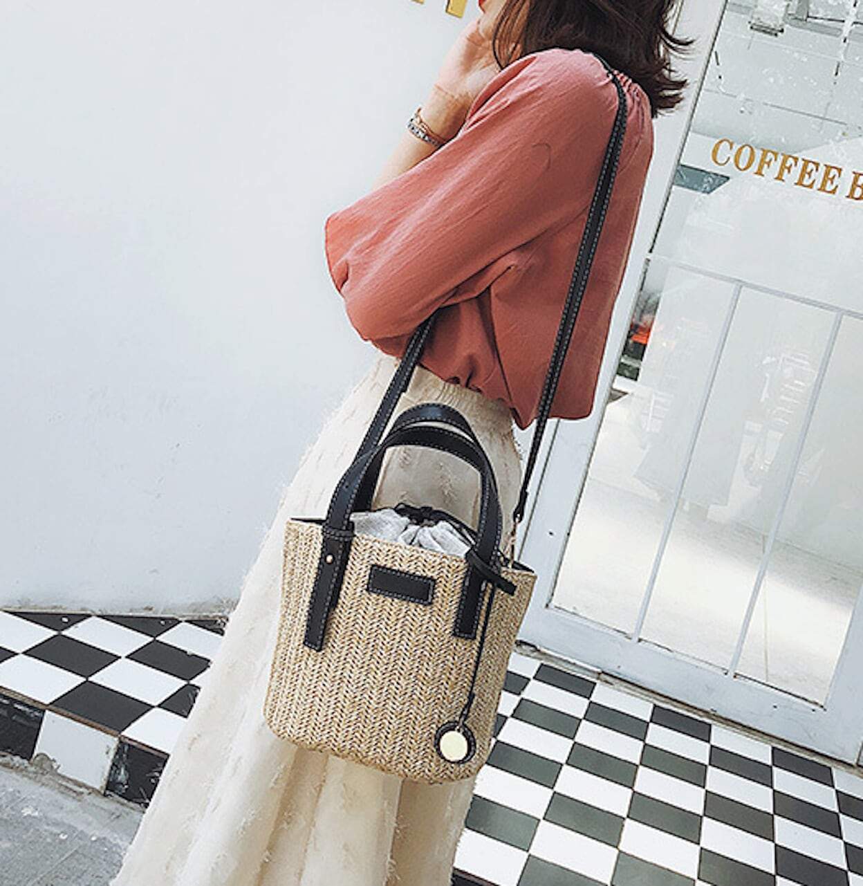 Stylish Straw Shoulder Bucket Bag featuring a Vegan Leather Handle, perfect for summer fashion.