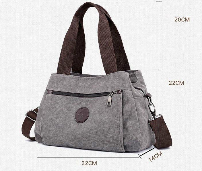 Women's Canvas Shoulder Messenger Bag in solid color, featuring multiple pockets and a zipper closure, perfect for everyday use.