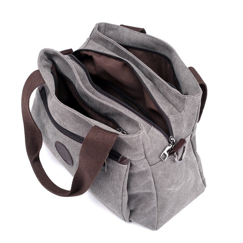 Women's Canvas Shoulder Messenger Bag in solid color, featuring multiple pockets and a zipper closure, perfect for everyday use.