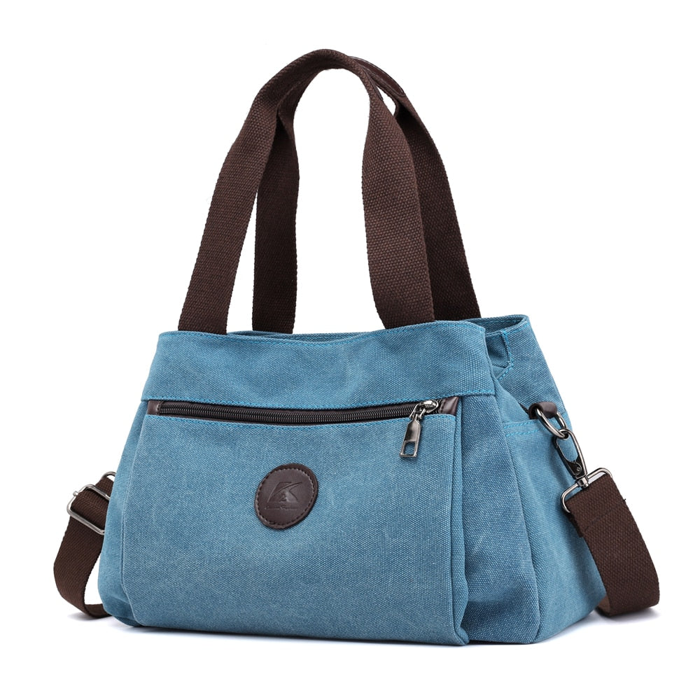 Women's Canvas Shoulder Messenger Bag in solid color, featuring multiple pockets and a zipper closure, perfect for everyday use.