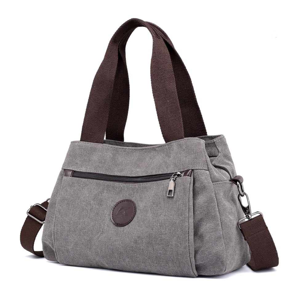 Women's Canvas Shoulder Messenger Bag in solid color, featuring multiple pockets and a zipper closure, perfect for everyday use.