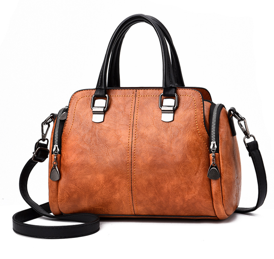 A stylish Women's High Quality Casual Messenger Bag made of soft PU fabric, featuring a Boston bag design with multiple internal pockets and a zipper closure.
