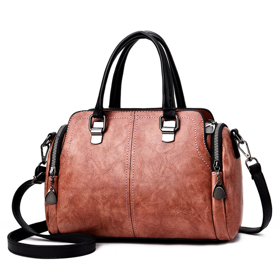 A stylish Women's High Quality Casual Messenger Bag made of soft PU fabric, featuring a Boston bag design with multiple internal pockets and a zipper closure.