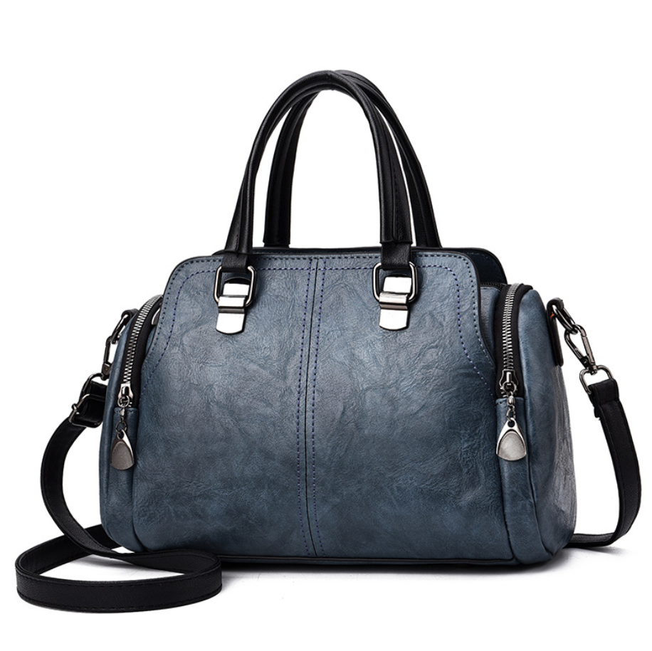 A stylish Women's High Quality Casual Messenger Bag made of soft PU fabric, featuring a Boston bag design with multiple internal pockets and a zipper closure.